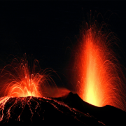 A volcano surges with red lava in the black night - an image of change from Victor via Albumarium