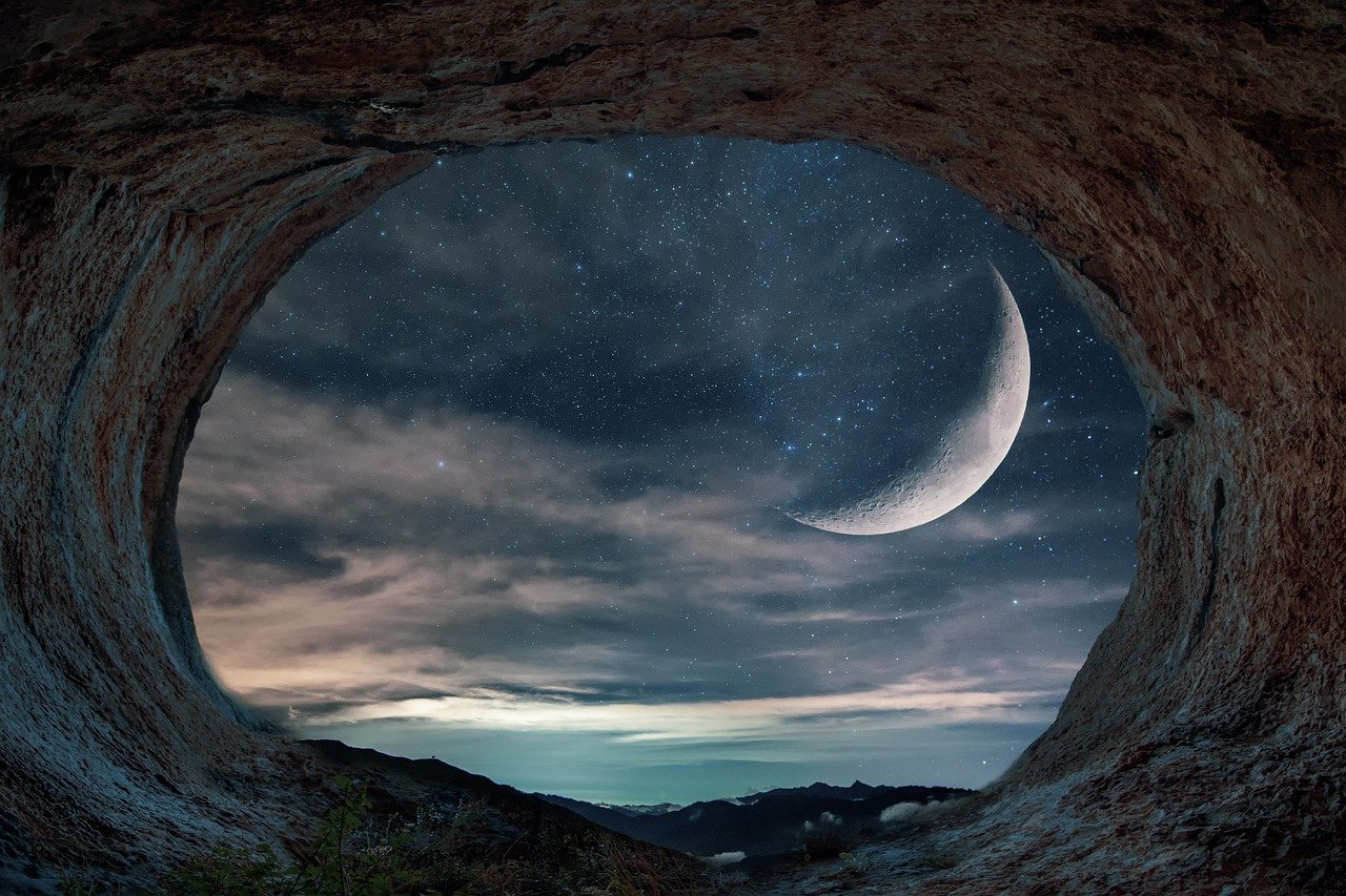 looking out from cave at sea and moon