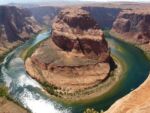 large red rock formation splitting a river into two sides