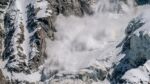 snow avalanche coming down a mountain with force