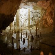opening to a cave with mineral deposits like an obstacle course
