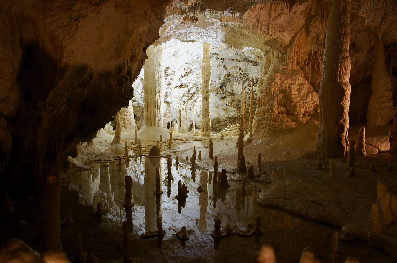 opening to a cave with mineral deposits like an obstacle course