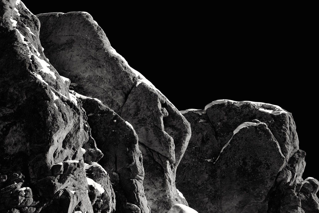 black and white photo of rocks in a dark setting; ominous