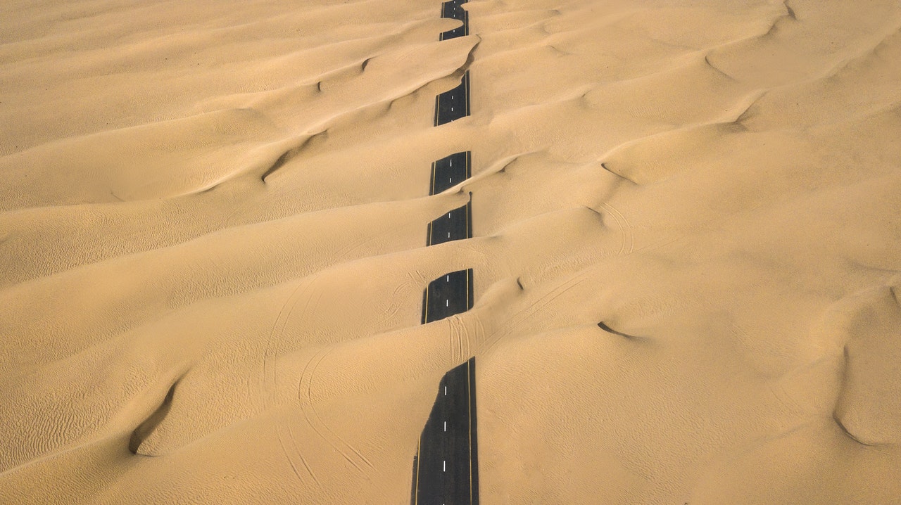 lostTheLazyArtistGallerypexels paved road almost totally covered by sand