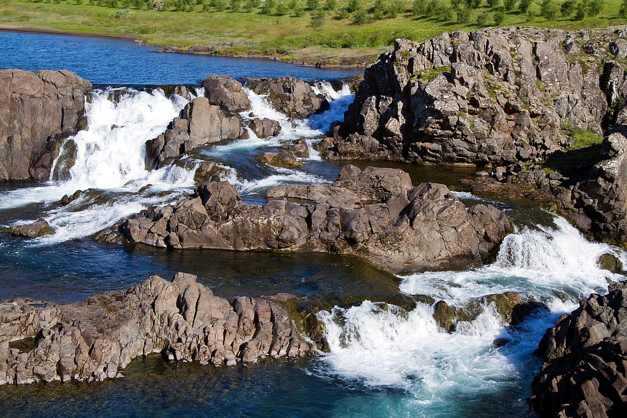 Waterfalls and rocks in a river in Iceland.