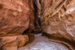 Narrow rock gorge with high walls and little space between them.