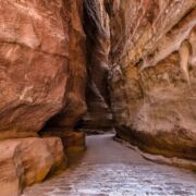 Narrow rock gorge with high walls and little space between them.
