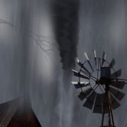 A farm windmill and barn roof in wind storm. Black and white photo.