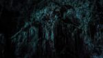 Dark cave wall with many indentations that evoke fear