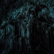 Dark cave wall with many indentations that evoke fear