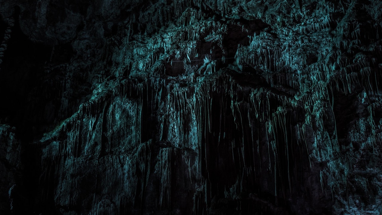 Dark cave wall with many indentations that evoke fear