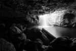 black and white-hot of rock cave with distant opening