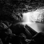 black and white-hot of rock cave with distant opening
