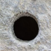 Light gray rock with dark hole in center