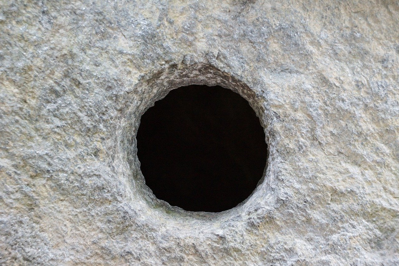 Light gray rock with dark hole in center