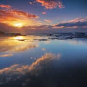 sunrise on water with clouds and reflections