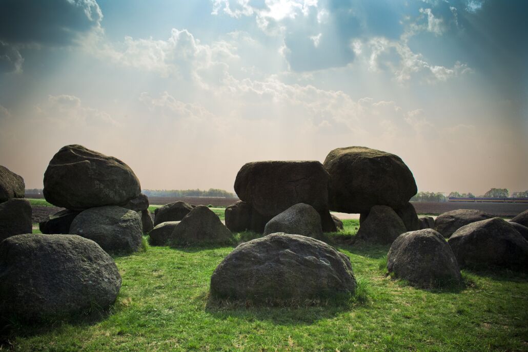 PiecesJoeriRomeralbumarium Blue sky and a field with boulders arranged haphazardly