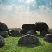 Blue sky and a field with boulders arranged haphazardly