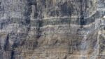 Gray, sheer rock wall with no openings.