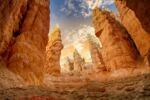 Red rock formation with tall, jagged rock towers.