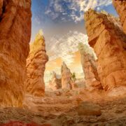 Red rock formation with tall, jagged rock towers.