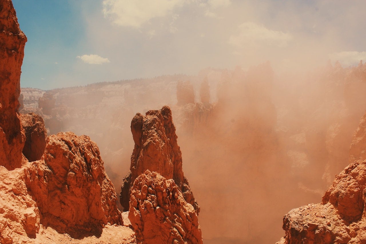 Red rock formation and blue sky in sandstorm