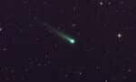 A NASA Agency photo of a comet in space surrounded by stars.
