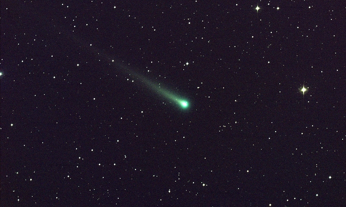A NASA Agency photo of a comet in space surrounded by stars.