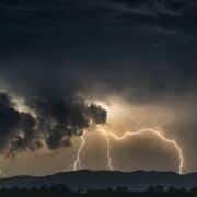 A dark sky, with dark clouds and threatening lightning.