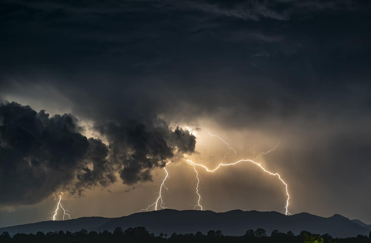 A dark sky, with dark clouds and threatening lightning.