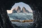 The edge of a cave looking out on a rugged mountainous landscape