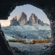 The edge of a cave looking out on a rugged mountainous landscape