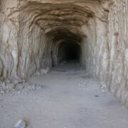 Opening to a cave. Plain gray rock with deep entrance