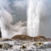 Multiple geysers spewing from a rocky surface.