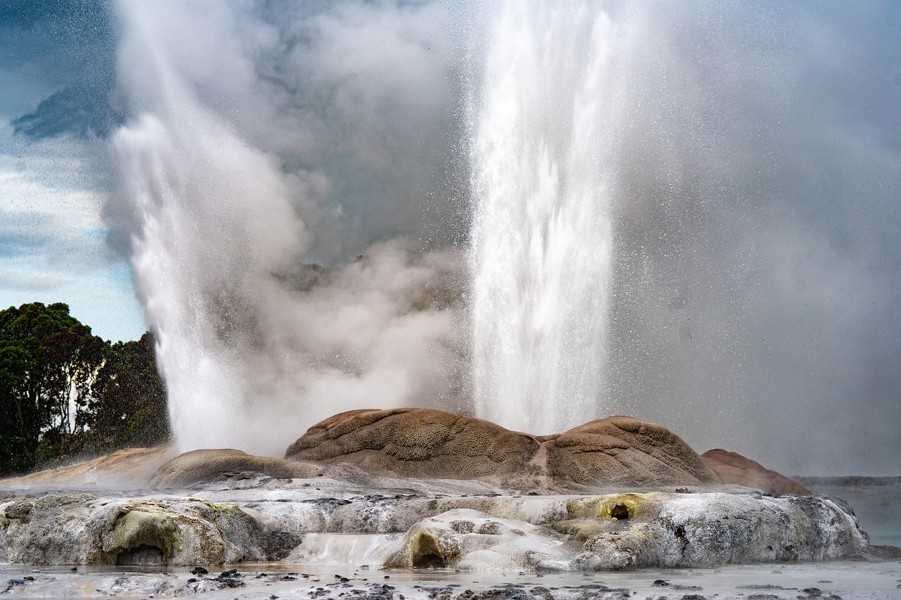 Multiple geysers spewing from a rocky surface.
