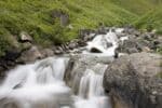 Rapids swiftly going down a river over rocks.