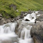 Rapids swiftly going down a river over rocks.