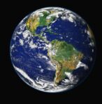 A color photo of earth from space with swirling clouds visible.
