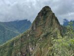 A strong mountain with trees on its slopes.