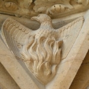 A stone carving of a phoenix on a cathedral.