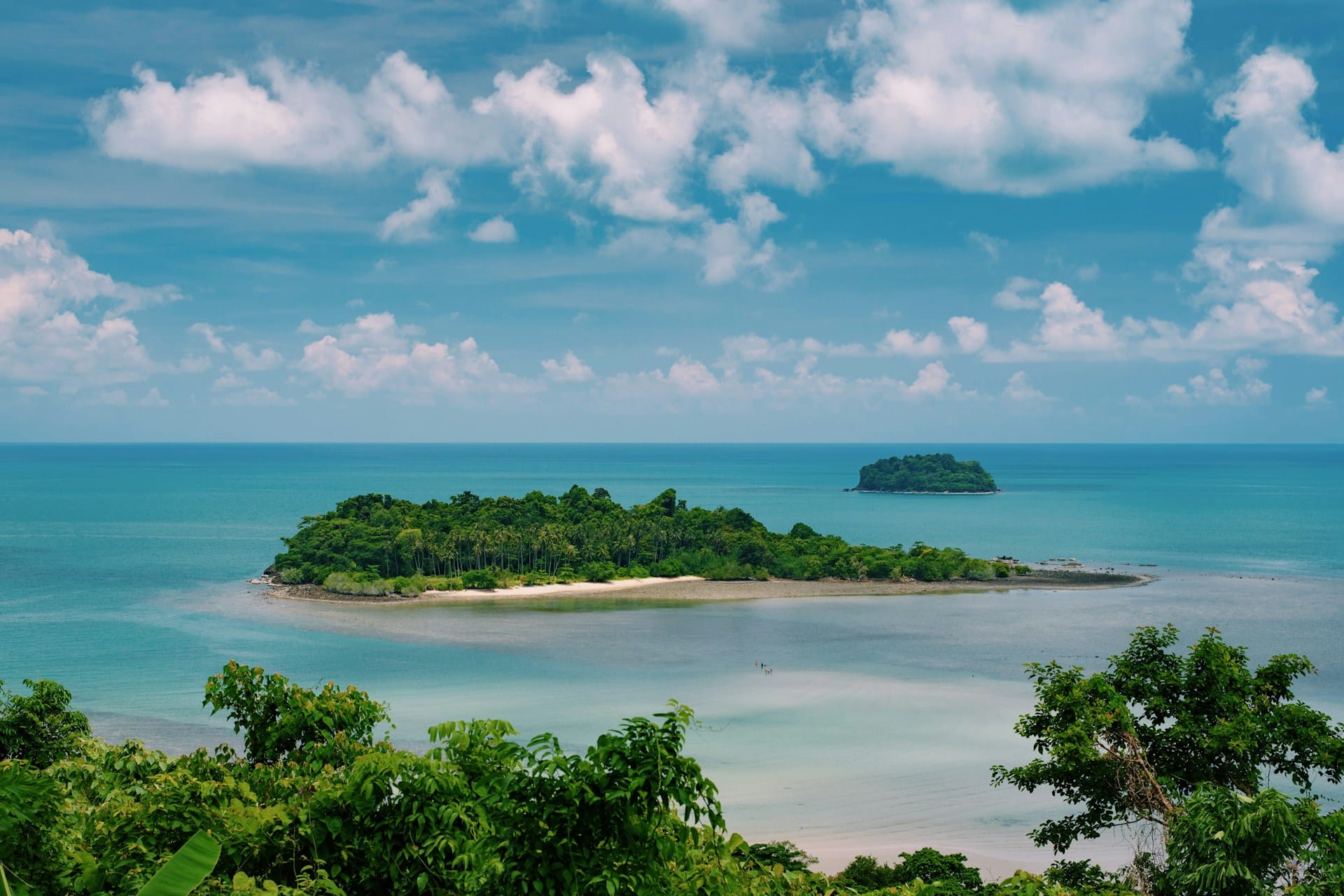 Small, tree-covered islands in a blue sea.