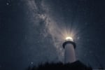 A photo of a lighthouse with a strong light, taken at an angle from the ground with a background of stars in the nighht sky.